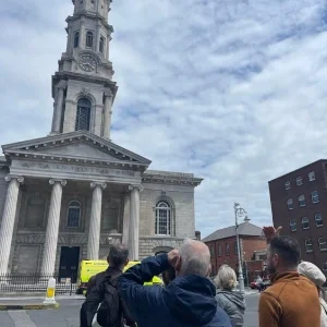 Group of people from a tour looking at a church in Dublin