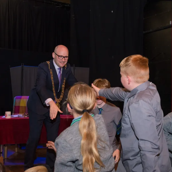 Ryan McAdams greetings school children