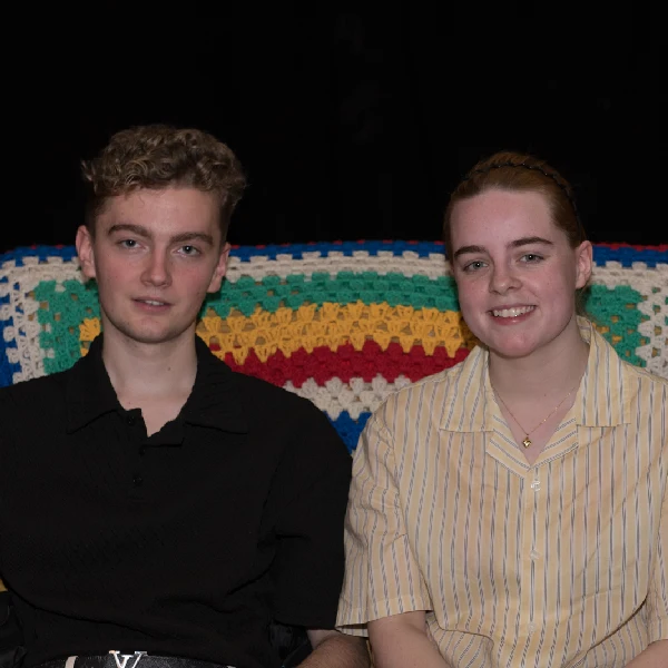 two teenagers sitting in a sofa