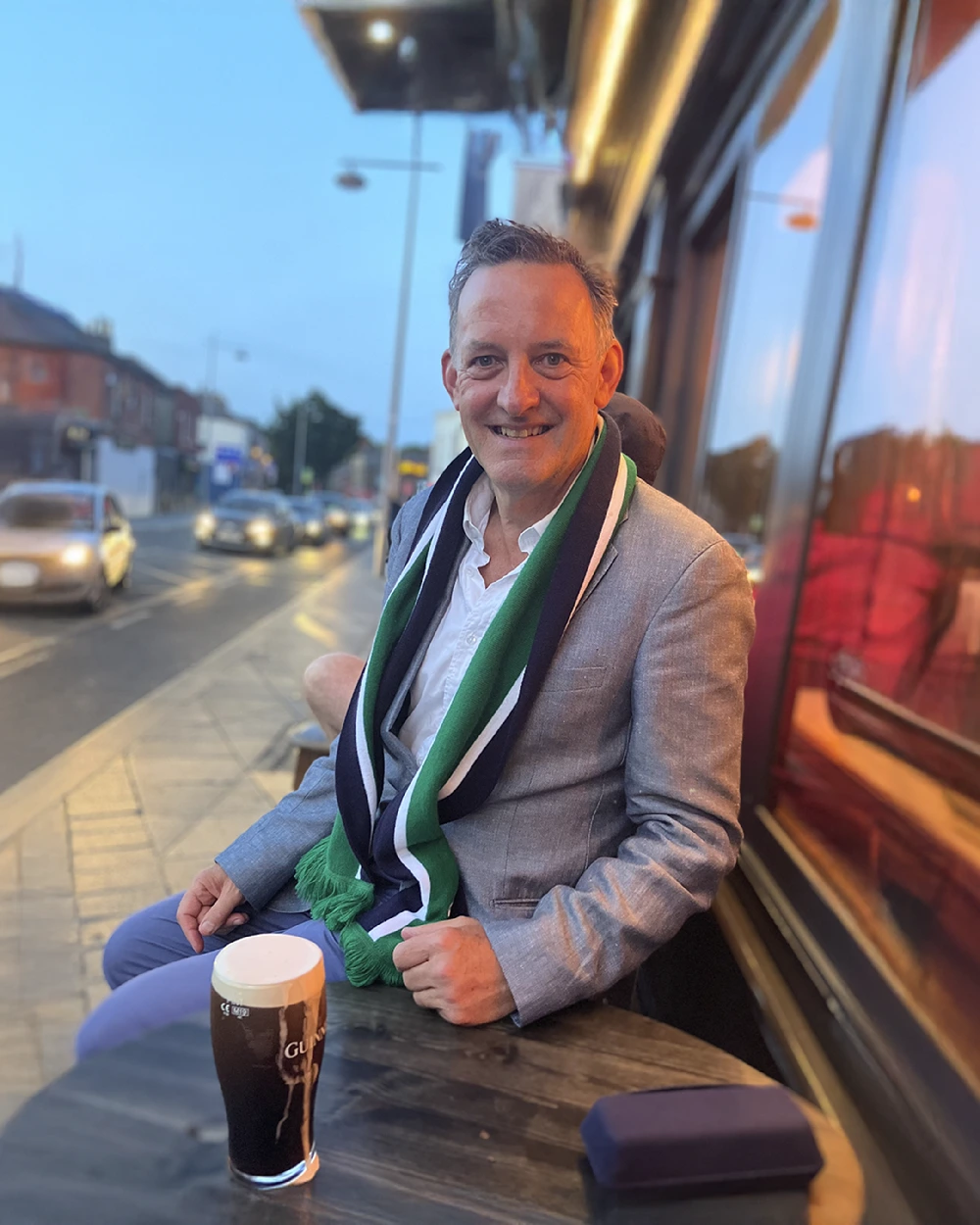 Patrick O'Dea sitting outside a pub having a pint of Guinness